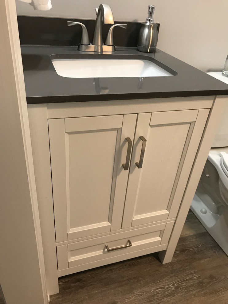 Small beach style master bathroom in Other with furniture-like cabinets, white cabinets, a two-piece toilet, grey walls, vinyl floors, an undermount sink, engineered quartz benchtops, grey floor and grey benchtops.