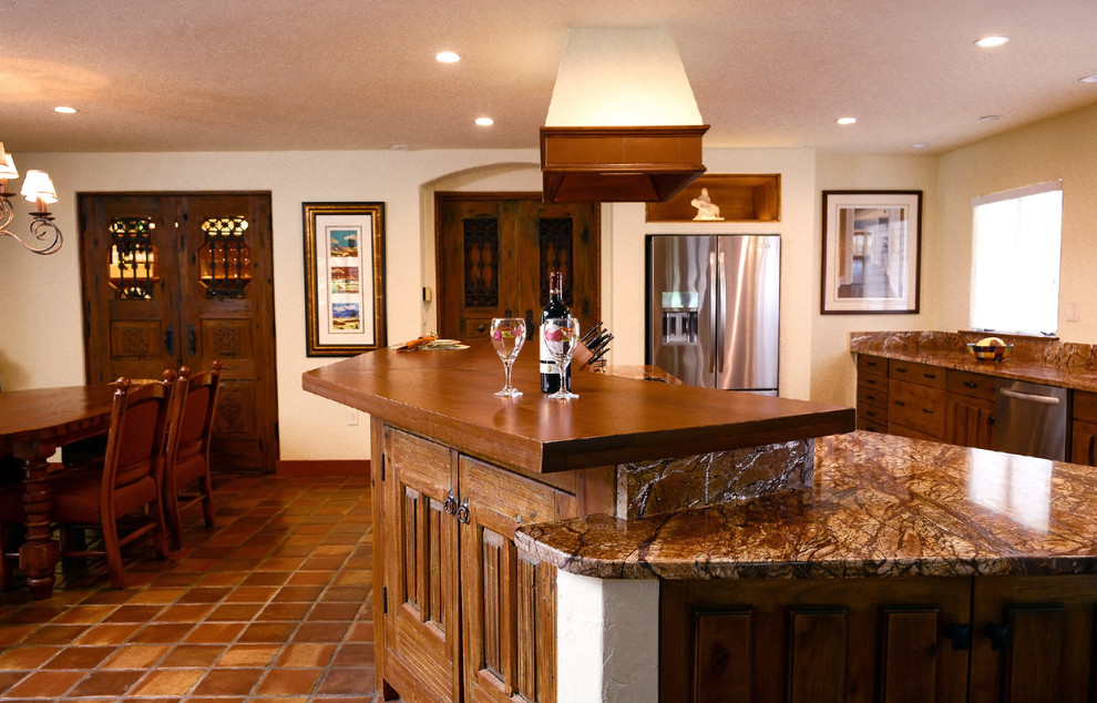 Open concept kitchen - mid-sized rustic u-shaped terra-cotta tile open concept kitchen idea in Boston with an undermount sink, dark wood cabinets, granite countertops and an island