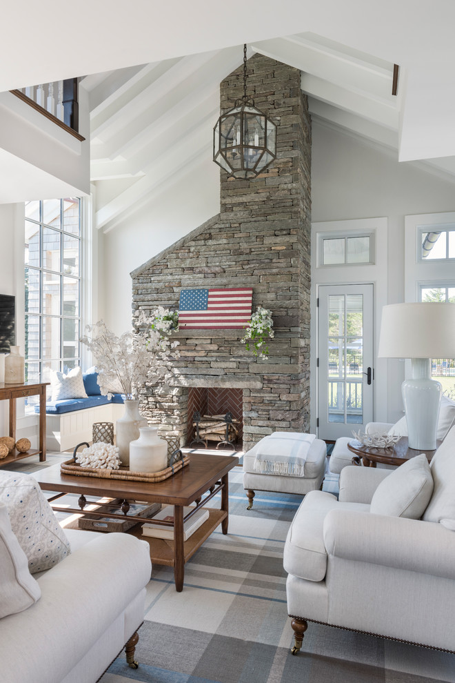 Photo of a beach style living room in Boston with grey walls, a standard fireplace and a stone fireplace surround.