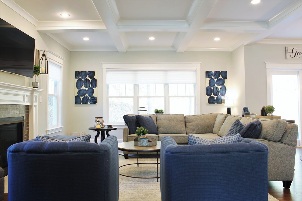 Example of a large transitional open concept dark wood floor and gray floor living room design in Boston with gray walls, a standard fireplace, a brick fireplace and a wall-mounted tv