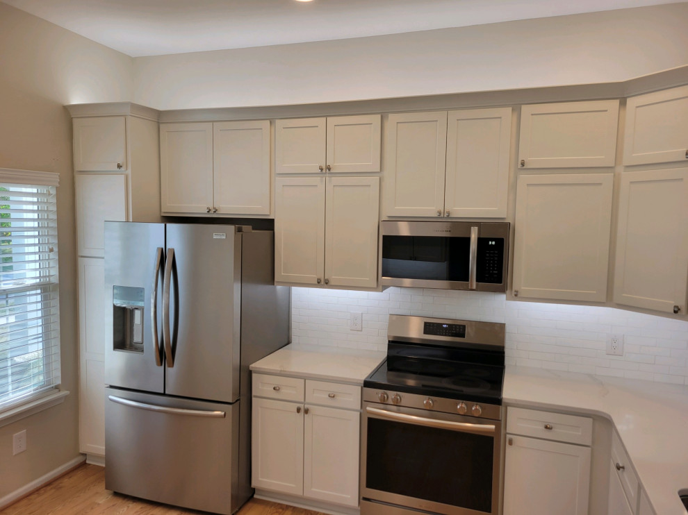Inspiration for a mid-sized transitional enclosed kitchen remodel with shaker cabinets, white cabinets, quartz countertops, white backsplash, subway tile backsplash and white countertops