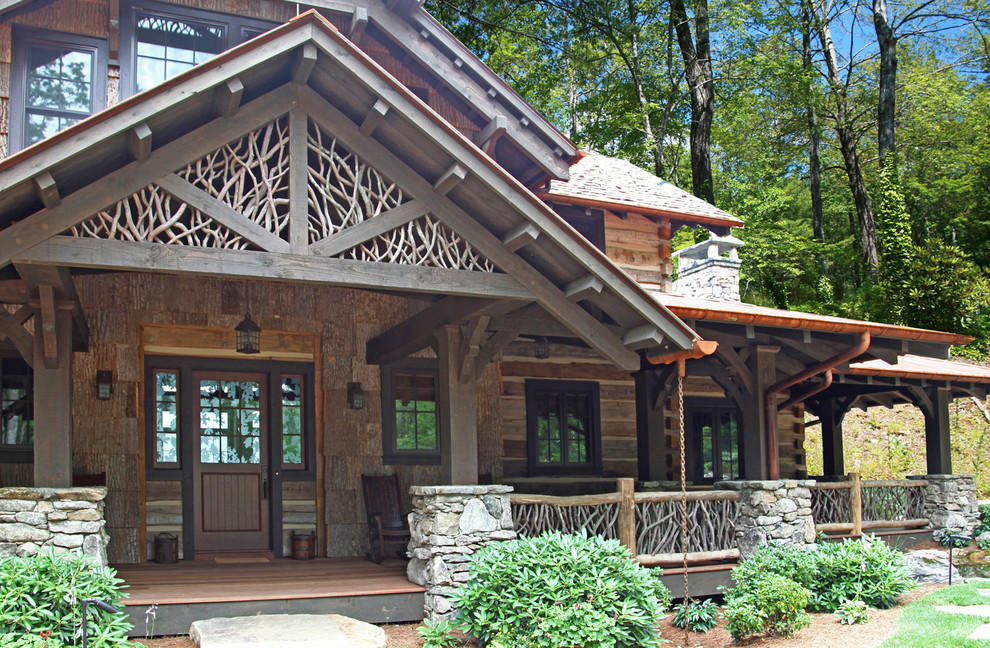 Inspiration for a large country two-storey brown exterior in Other with wood siding.