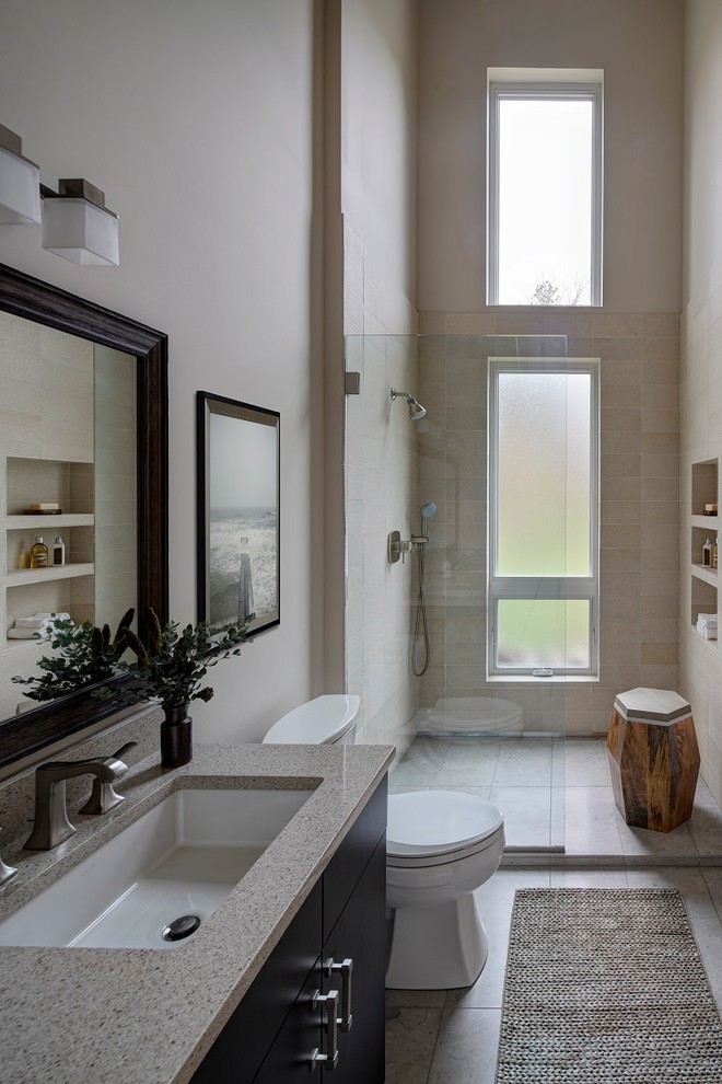 Design ideas for a mid-sized contemporary master bathroom in Chicago with flat-panel cabinets, dark wood cabinets, an alcove tub, an alcove shower, a two-piece toilet, beige tile, limestone, beige walls, an undermount sink, solid surface benchtops, beige floor and an open shower.