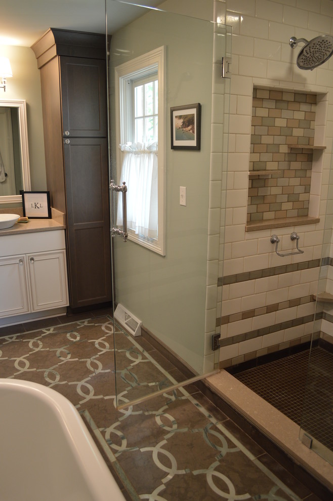 This is an example of a mid-sized traditional master bathroom in Cleveland with a vessel sink, recessed-panel cabinets, white cabinets, engineered quartz benchtops, a freestanding tub, an open shower, a two-piece toilet, brown tile, green walls and porcelain floors.
