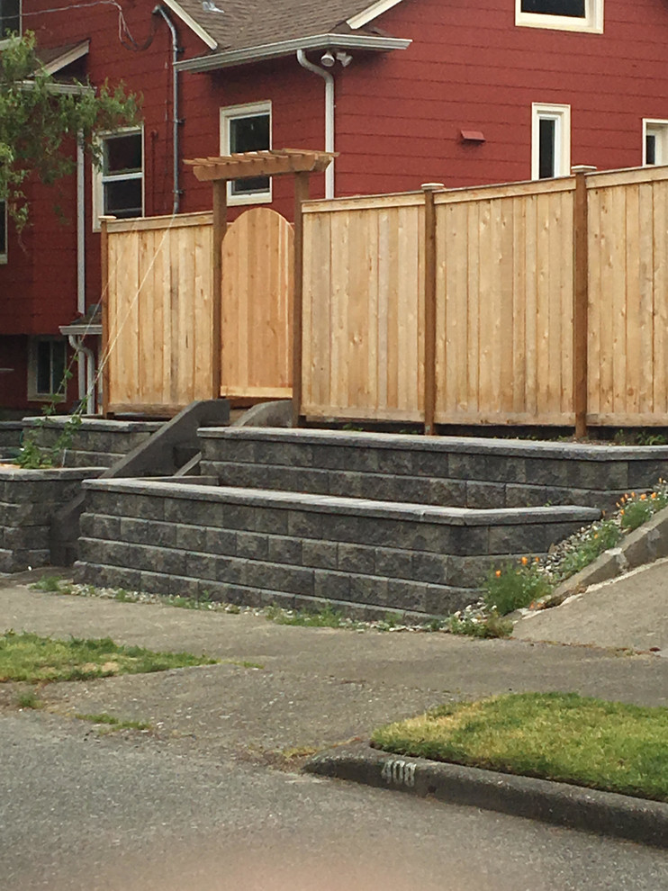 Inspiration for a mid-sized traditional side yard full sun garden in Seattle with a retaining wall.