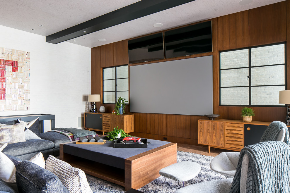 Design ideas for a transitional home theatre in Los Angeles with a projector screen.