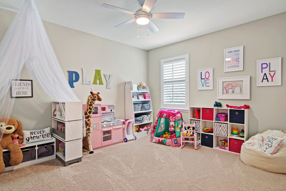 Transitional gender-neutral kids' room in Jacksonville with beige walls, carpet and beige floor.