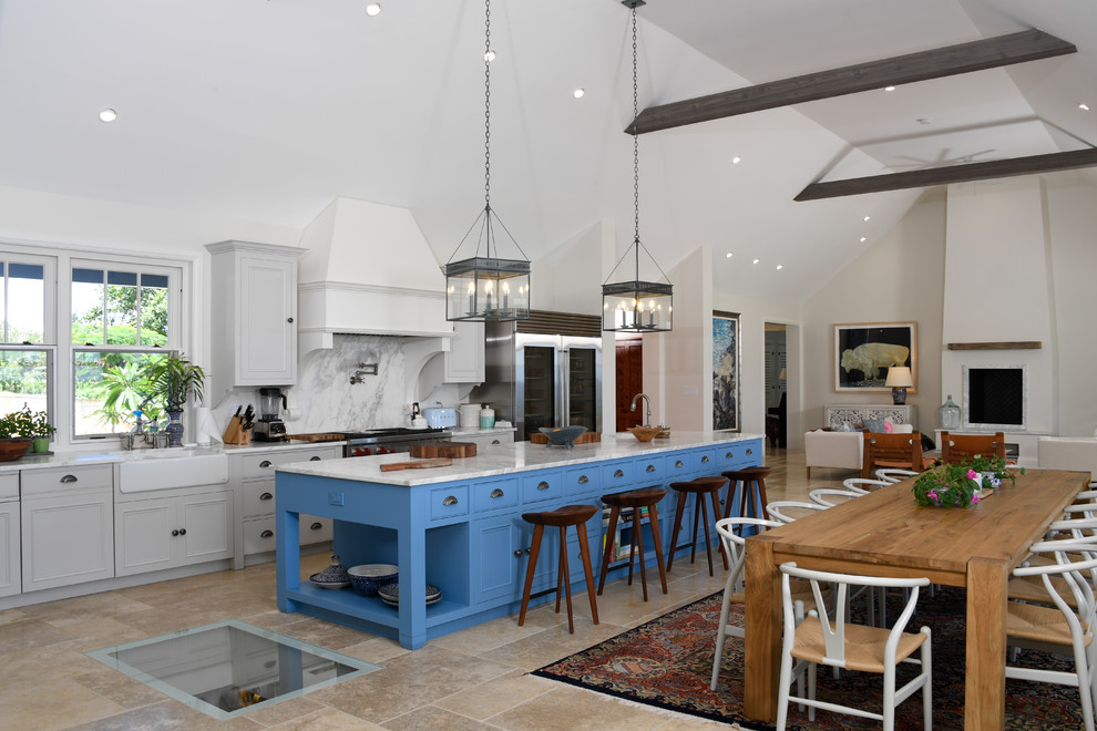 Expansive beach style open plan kitchen in Miami with a farmhouse sink, recessed-panel cabinets, grey cabinets, white splashback, stone slab splashback, with island, beige floor and white benchtop.