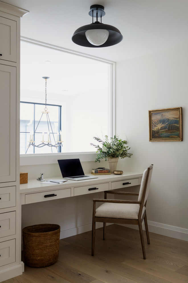 Study room - transitional built-in desk medium tone wood floor and brown floor study room idea in Seattle with gray walls
