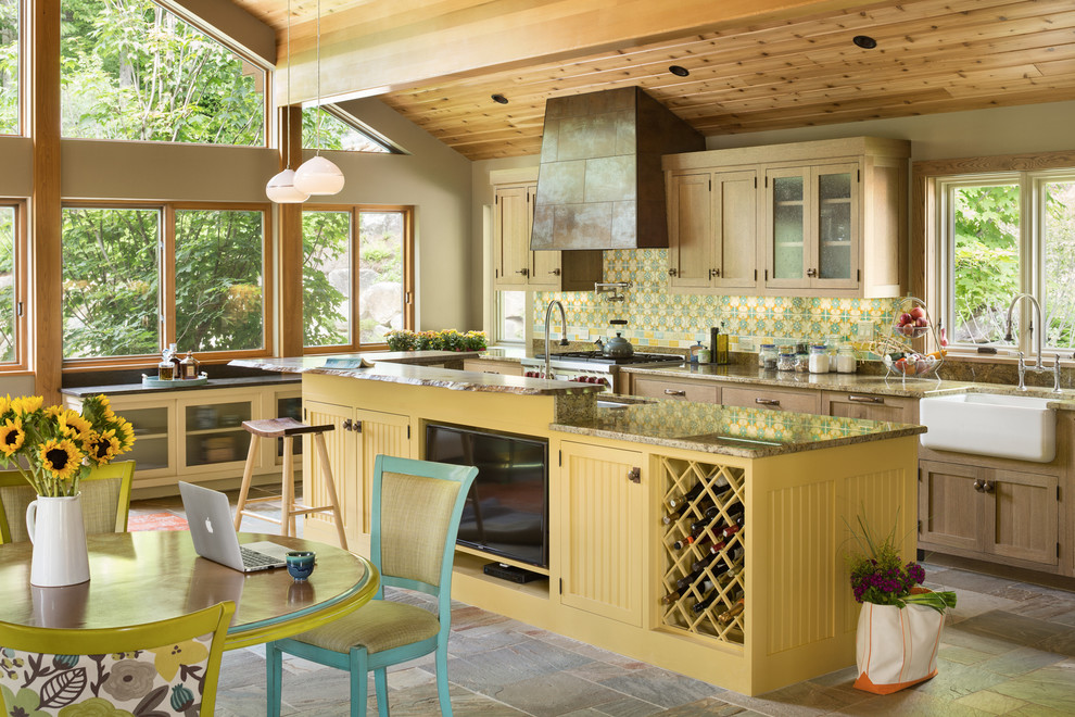 Photo of a large arts and crafts u-shaped eat-in kitchen in Portland Maine with a farmhouse sink, light wood cabinets, granite benchtops, multi-coloured splashback, mosaic tile splashback, slate floors, with island, stainless steel appliances, multi-coloured floor and shaker cabinets.