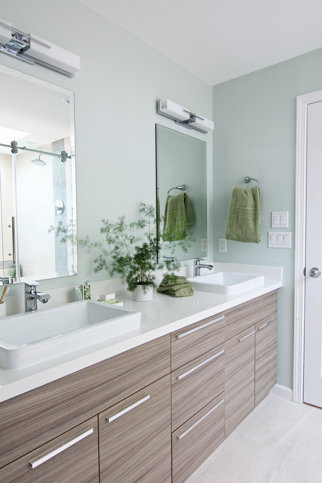 Mid-sized modern master bathroom in Seattle with flat-panel cabinets, light wood cabinets, a drop-in tub, an open shower, a one-piece toilet, beige tile, porcelain tile, green walls, porcelain floors, a vessel sink and engineered quartz benchtops.