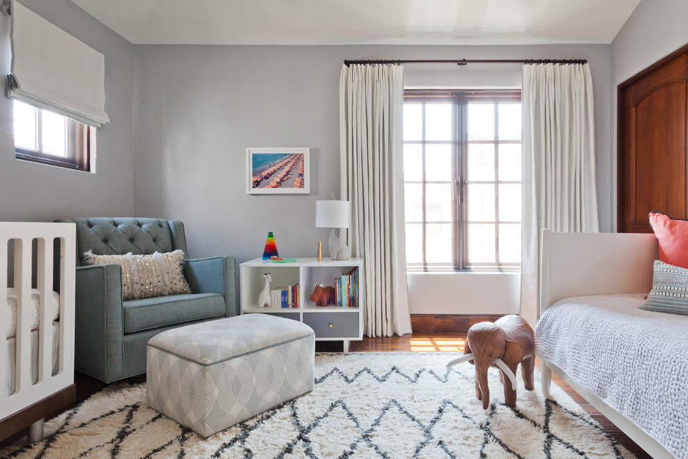 Design ideas for a mid-sized transitional gender-neutral nursery in Los Angeles with grey walls, medium hardwood floors and brown floor.
