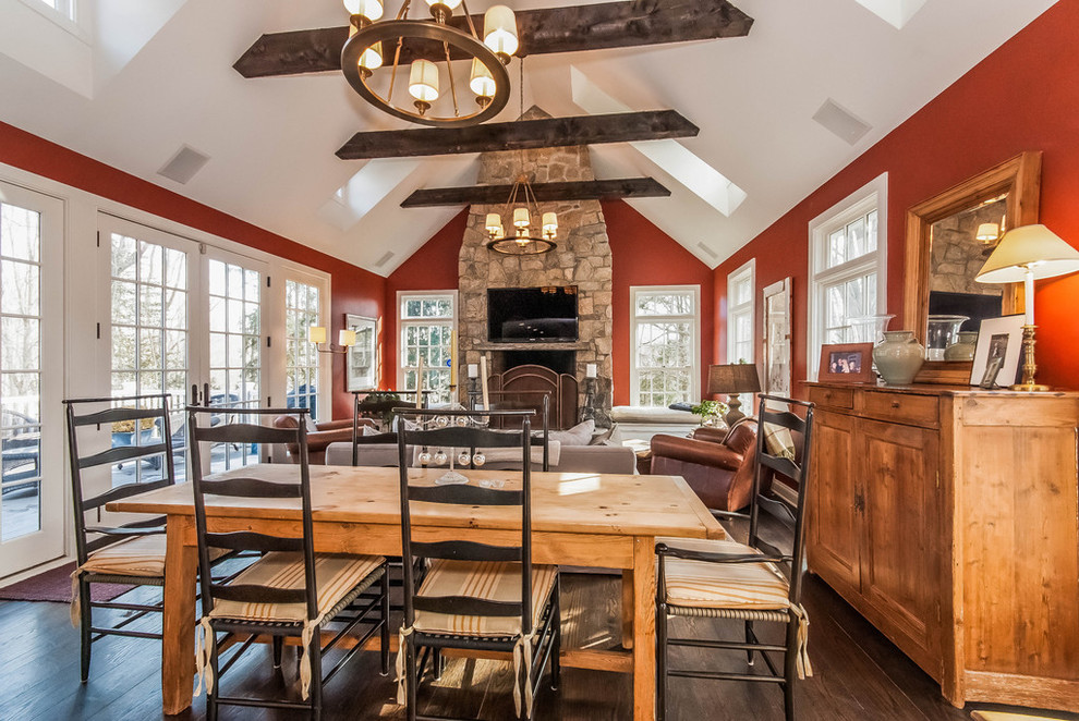 Large country open plan dining in New York with red walls, dark hardwood floors and brown floor.