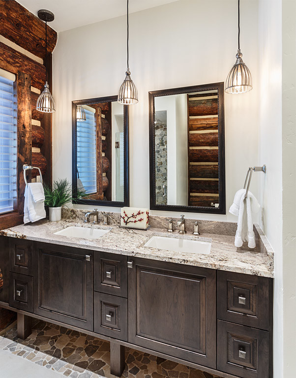This is an example of a mid-sized country 3/4 bathroom in Albuquerque with an undermount sink, recessed-panel cabinets, distressed cabinets, granite benchtops, a corner shower, a two-piece toilet, white tile, pebble tile, grey walls and medium hardwood floors.