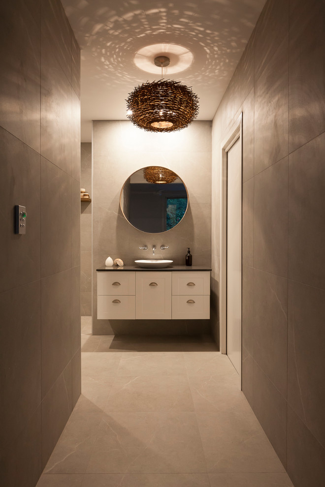 Inspiration for a large contemporary master bathroom in Sydney with shaker cabinets, white cabinets, a freestanding tub, a double shower, a one-piece toilet, gray tile, porcelain tile, grey walls, porcelain floors, a pedestal sink and engineered quartz benchtops.