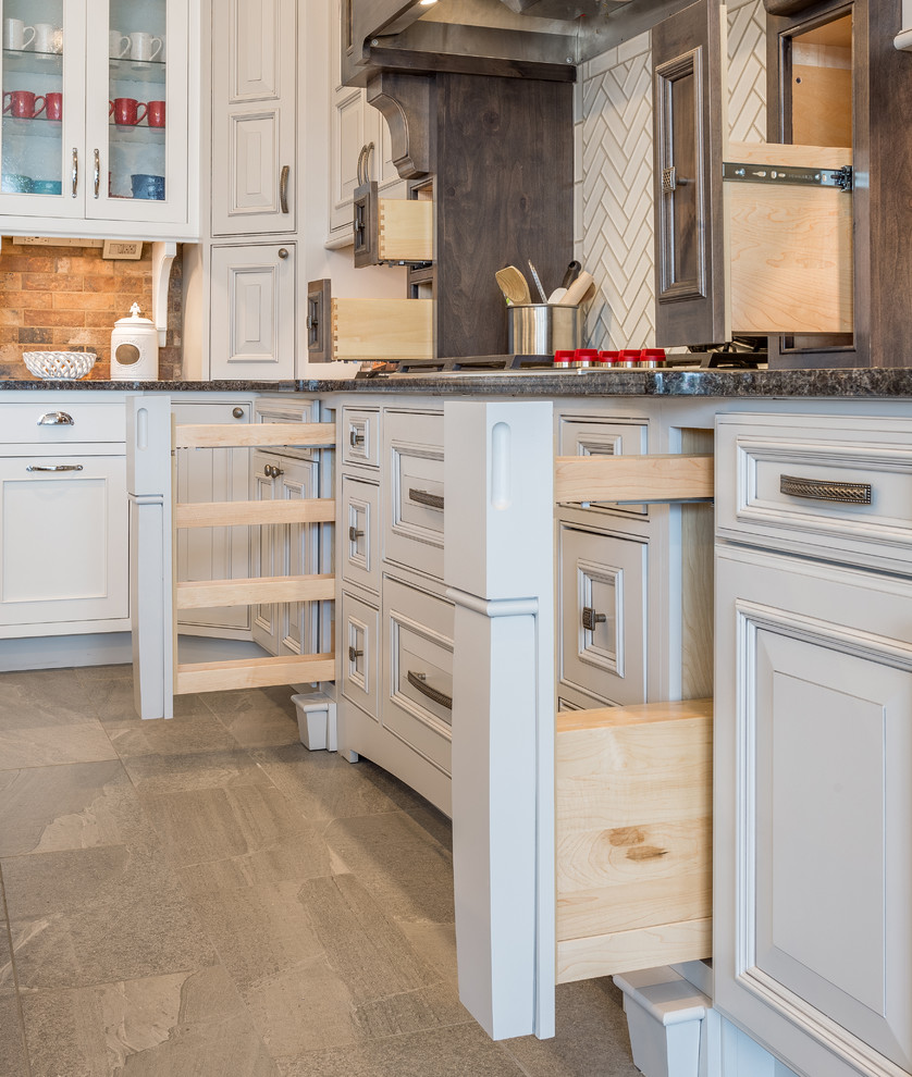 Open concept kitchen - large transitional l-shaped gray floor open concept kitchen idea with shaker cabinets, medium tone wood cabinets, granite countertops, white backsplash, subway tile backsplash, stainless steel appliances and an island
