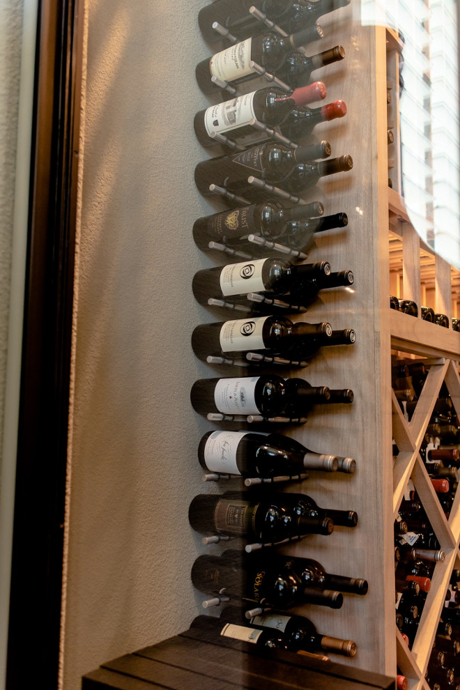 This is an example of a contemporary wine cellar in Dallas.