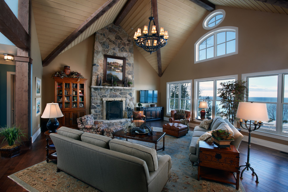 Photo of a large arts and crafts formal open concept living room in Other with beige walls, dark hardwood floors, a standard fireplace and a stone fireplace surround.