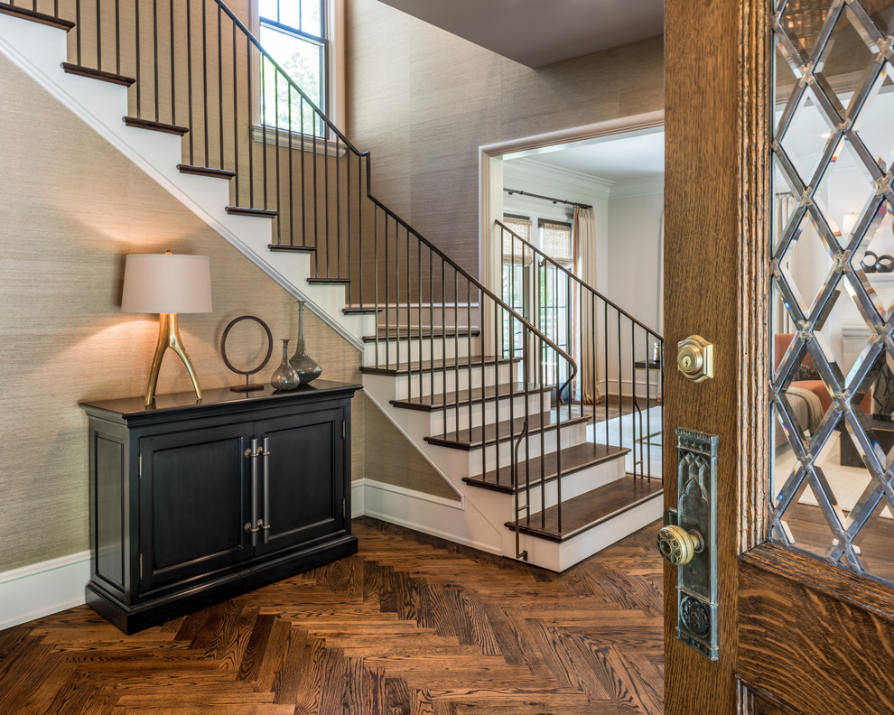 This is an example of a transitional foyer in Philadelphia with brown walls, dark hardwood floors, a single front door and a dark wood front door.