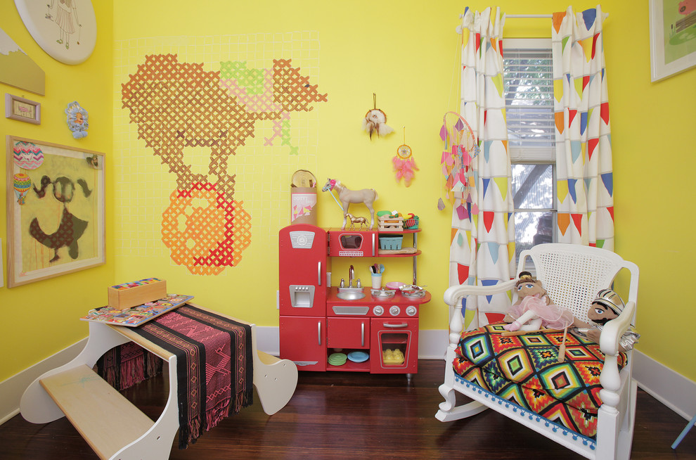 Inspiration for an eclectic kids' room for girls in Dallas with yellow walls and dark hardwood floors.