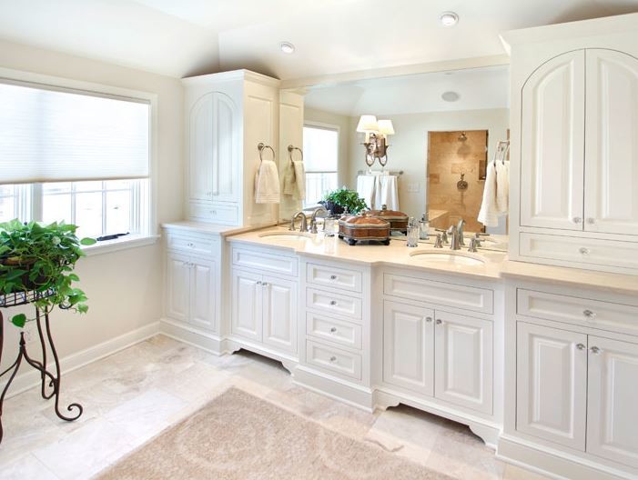 Photo of a large traditional master bathroom in Minneapolis with raised-panel cabinets, white cabinets, an alcove shower, white walls, travertine floors, an undermount sink and limestone benchtops.
