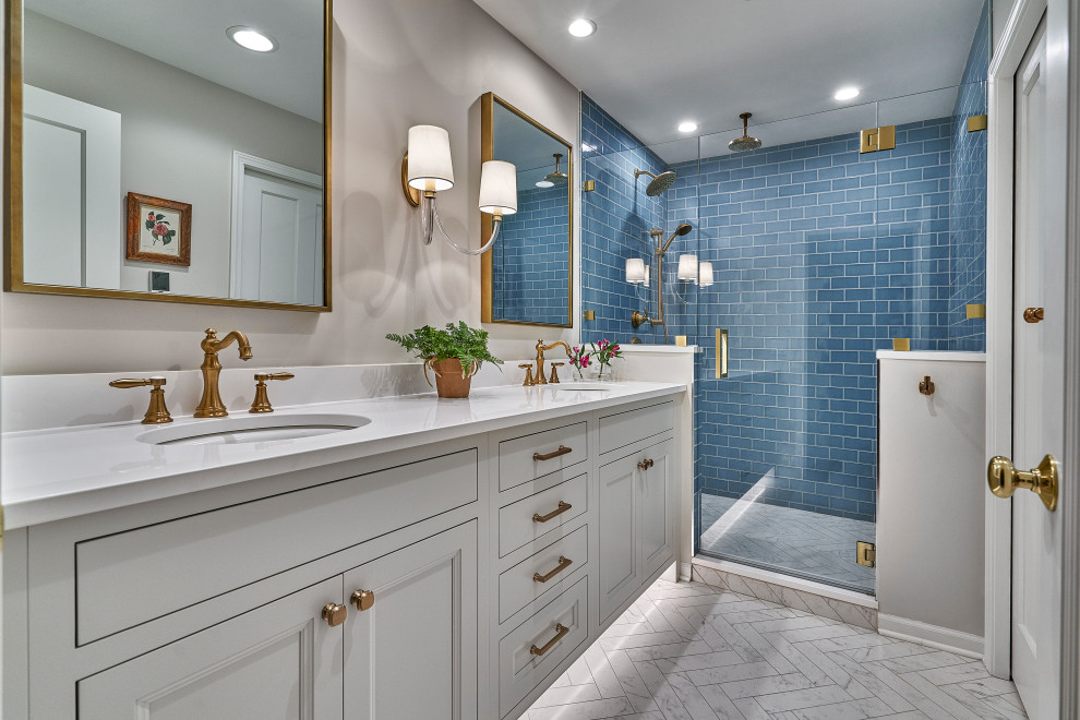 This is an example of a mid-sized traditional master bathroom in Chicago with recessed-panel cabinets, white cabinets, a two-piece toilet, blue tile, ceramic tile, white walls, marble floors, an undermount sink, engineered quartz benchtops, white floor, a hinged shower door, white benchtops, a shower seat, a double vanity and a built-in vanity.