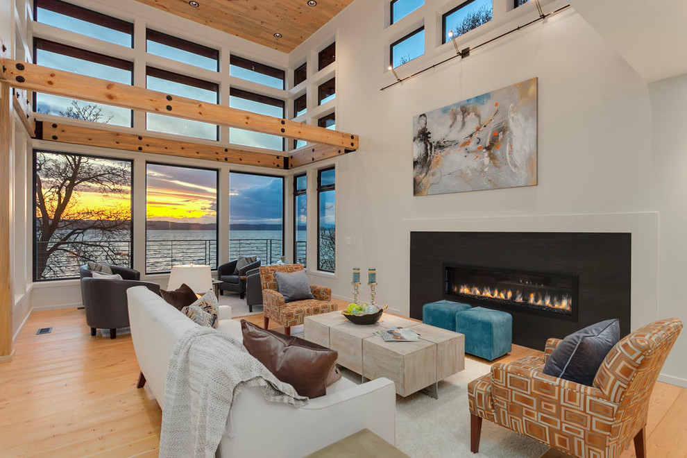 Inspiration for a mid-sized contemporary formal open concept living room in Seattle with white walls, light hardwood floors, a ribbon fireplace, beige floor, a metal fireplace surround, no tv and wood.
