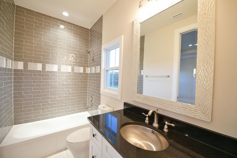 Mid-sized contemporary bathroom in Orlando with shaker cabinets, white cabinets, an alcove tub, a shower/bathtub combo, brown tile, subway tile, porcelain floors, an undermount sink, granite benchtops and grey floor.