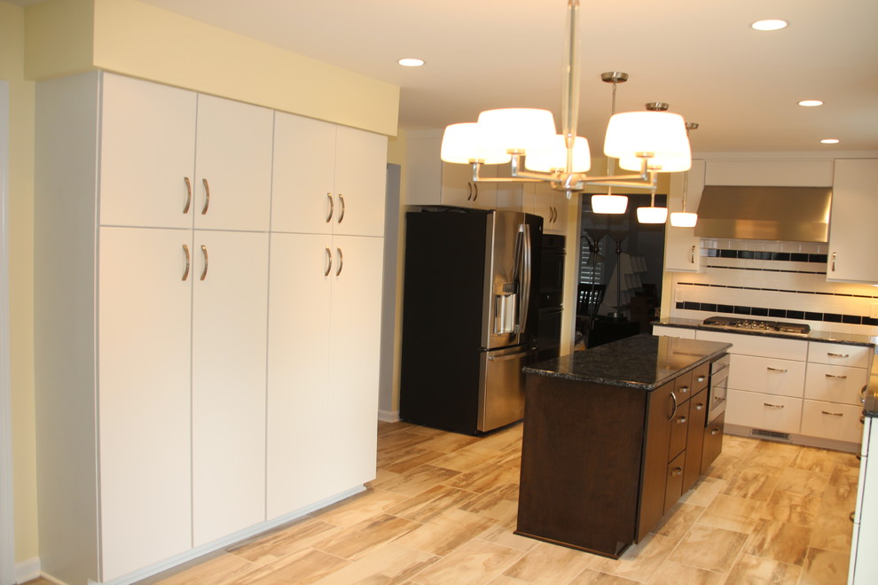 Inspiration for a mid-sized transitional u-shaped porcelain tile and beige floor eat-in kitchen remodel in DC Metro with an undermount sink, flat-panel cabinets, white cabinets, quartz countertops, white backsplash, ceramic backsplash, stainless steel appliances, an island and black countertops