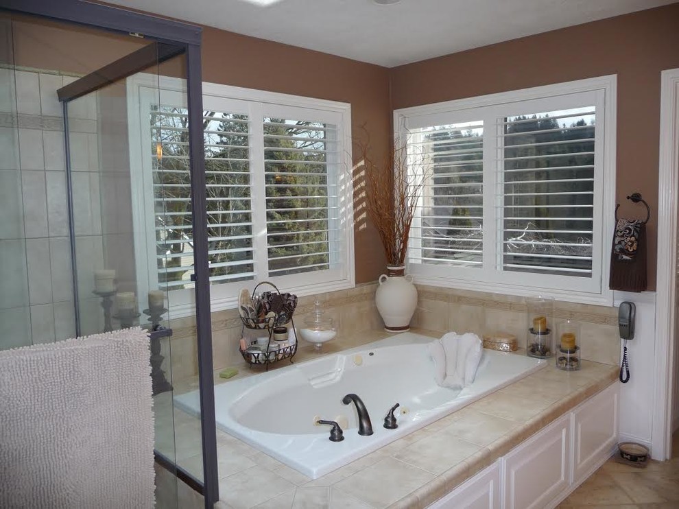 Inspiration for a large transitional master bathroom in Portland with raised-panel cabinets, white cabinets, a corner tub, beige tile, ceramic tile, brown walls, ceramic floors, an open shower, a one-piece toilet, a drop-in sink and concrete benchtops.