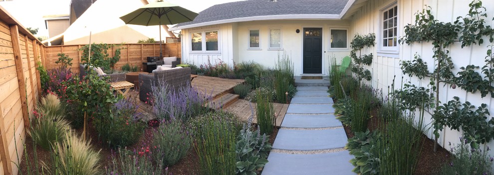 Mid-sized mediterranean front yard full sun xeriscape in San Francisco with a garden path and decking for summer.