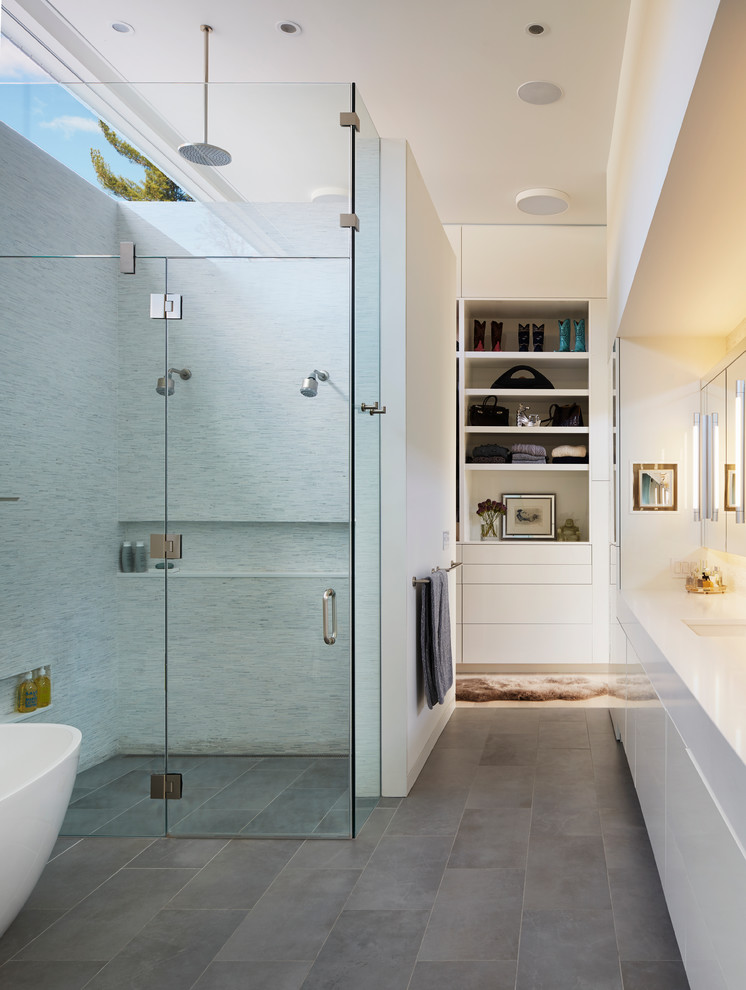 Inspiration for a midcentury bathroom in New York with flat-panel cabinets, white cabinets, a freestanding tub, an alcove shower, white tile, matchstick tile, white walls, an undermount sink and a hinged shower door.