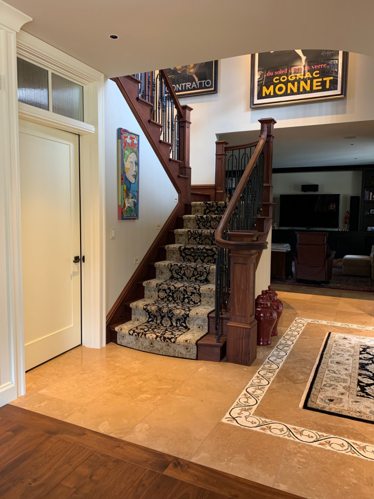 This is an example of a large transitional front door in Seattle with beige walls, dark hardwood floors and brown floor.