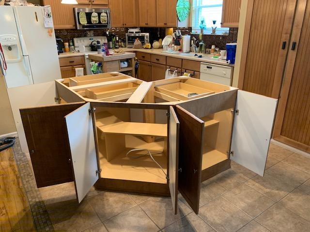 Eat-in kitchen - mid-sized eat-in kitchen idea with louvered cabinets, brown cabinets and an island