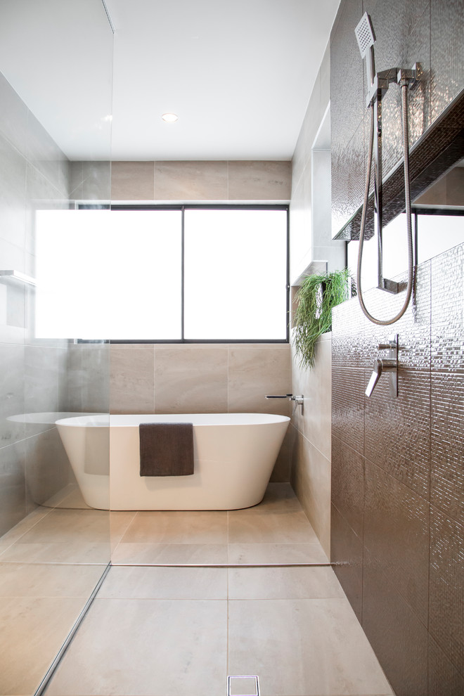 Design ideas for a large modern master bathroom in Brisbane with raised-panel cabinets, medium wood cabinets, a freestanding tub, an open shower, a one-piece toilet, beige tile, ceramic tile, beige walls, ceramic floors, a vessel sink, solid surface benchtops, beige floor and an open shower.