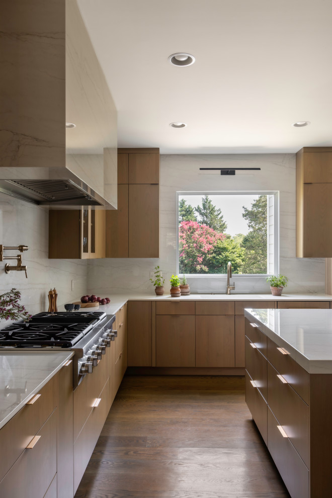 Inspiration for a large contemporary u-shaped medium tone wood floor and brown floor open concept kitchen remodel in DC Metro with an undermount sink, flat-panel cabinets, medium tone wood cabinets, quartz countertops, white backsplash, quartz backsplash, paneled appliances, an island and white countertops