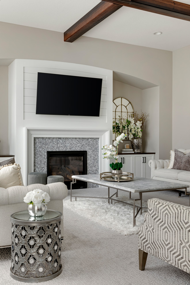 Photo of a mid-sized transitional formal open concept living room in Minneapolis with beige walls, carpet, a standard fireplace, a tile fireplace surround, a wall-mounted tv, white floor and exposed beam.