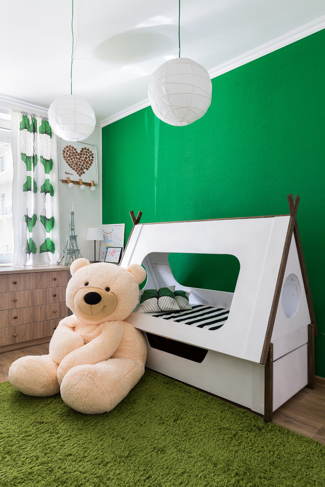 Photo of a small gender-neutral kids' bedroom for kids 4-10 years old in Saint Petersburg with green walls, laminate floors and beige floor.