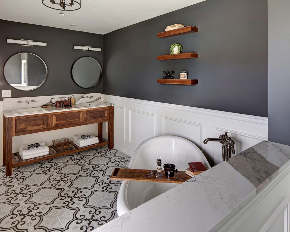 Example of a large transitional master porcelain tile, multicolored floor, double-sink and wainscoting freestanding bathtub design in New York with recessed-panel cabinets, medium tone wood cabinets, black walls, a drop-in sink, quartz countertops, white countertops and a freestanding vanity