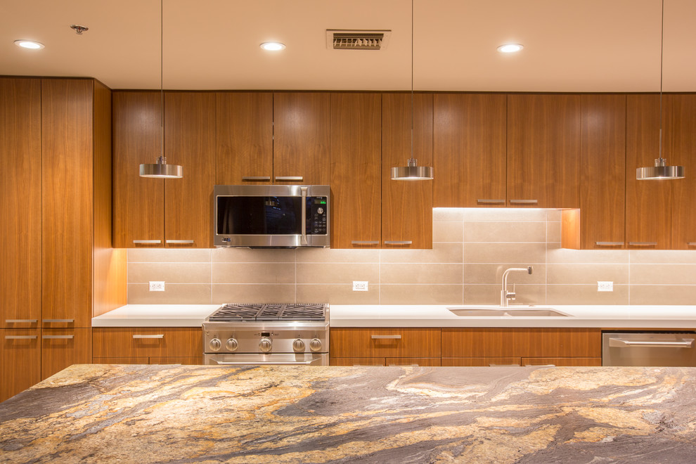 Mid-sized transitional l-shaped travertine floor and beige floor enclosed kitchen photo in Phoenix with an undermount sink, flat-panel cabinets, medium tone wood cabinets, onyx countertops, beige backsplash, porcelain backsplash, stainless steel appliances and an island