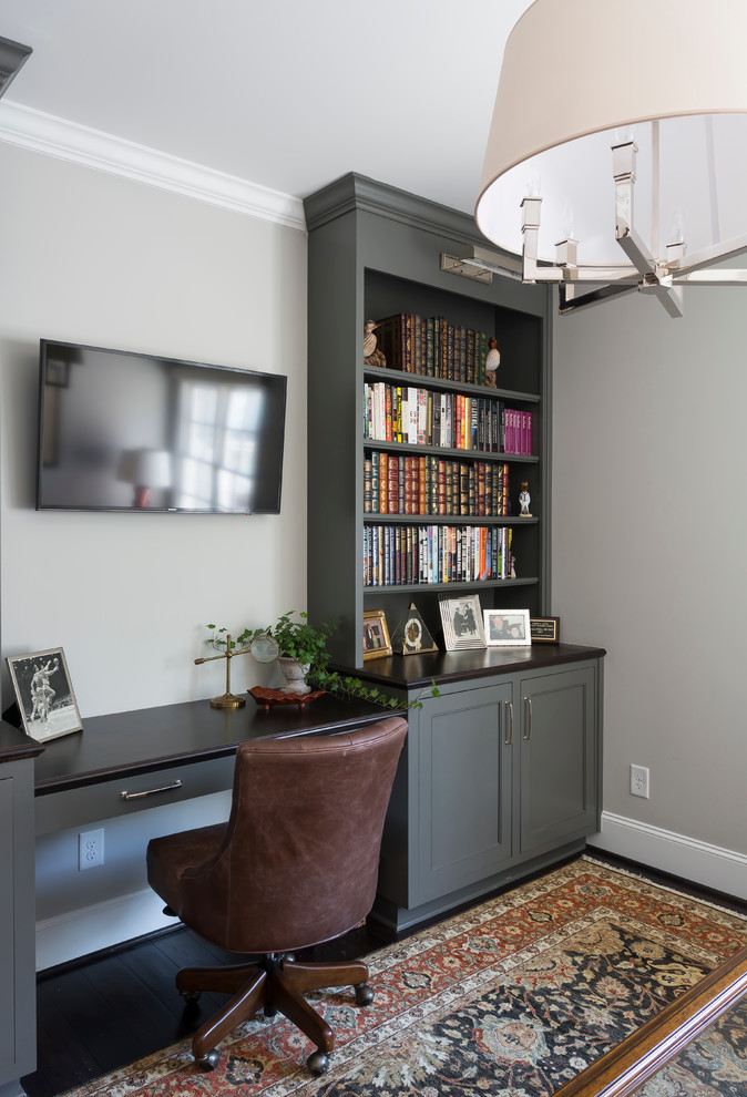 This is an example of a traditional study room in Charlotte with grey walls, dark hardwood floors, no fireplace and a built-in desk.