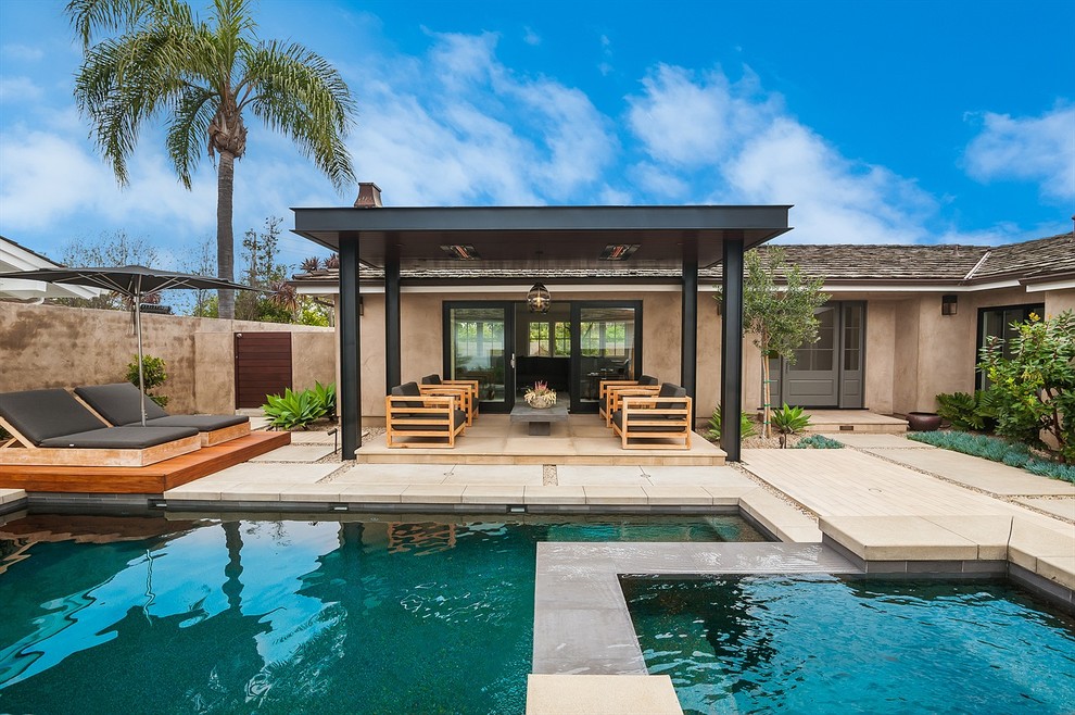 This is an example of a small contemporary courtyard rectangular lap pool in Orange County with a water feature and concrete pavers.