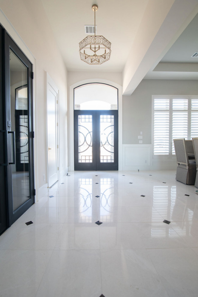 Inspiration for a large transitional porcelain tile and white floor foyer remodel in Houston with white walls and a metal front door