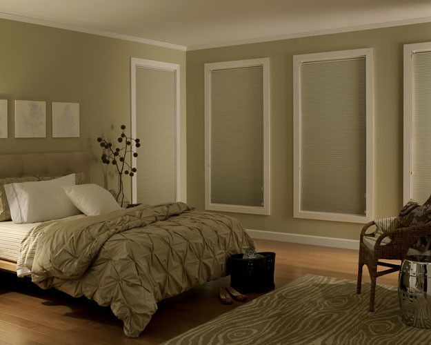 Inspiration for a mid-sized modern master bedroom in Vancouver with beige walls and light hardwood floors.