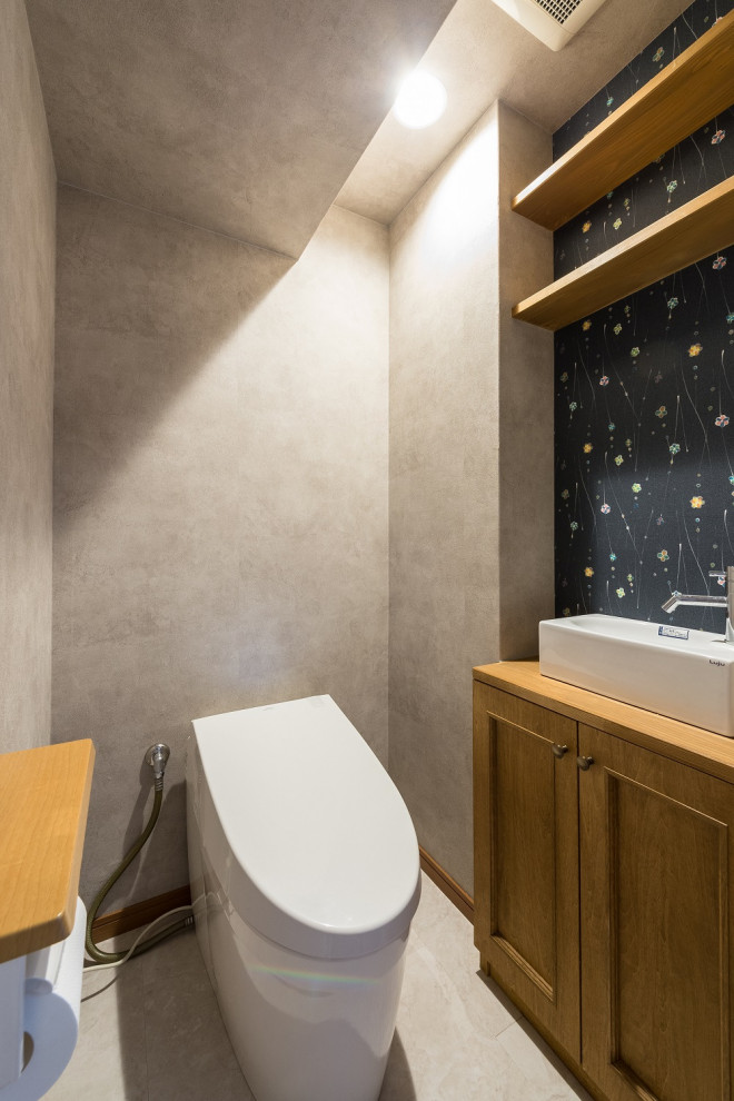 Inspiration for a cloakroom in Fukuoka with beaded cabinets, medium wood cabinets, a one-piece toilet and a built in vanity unit.