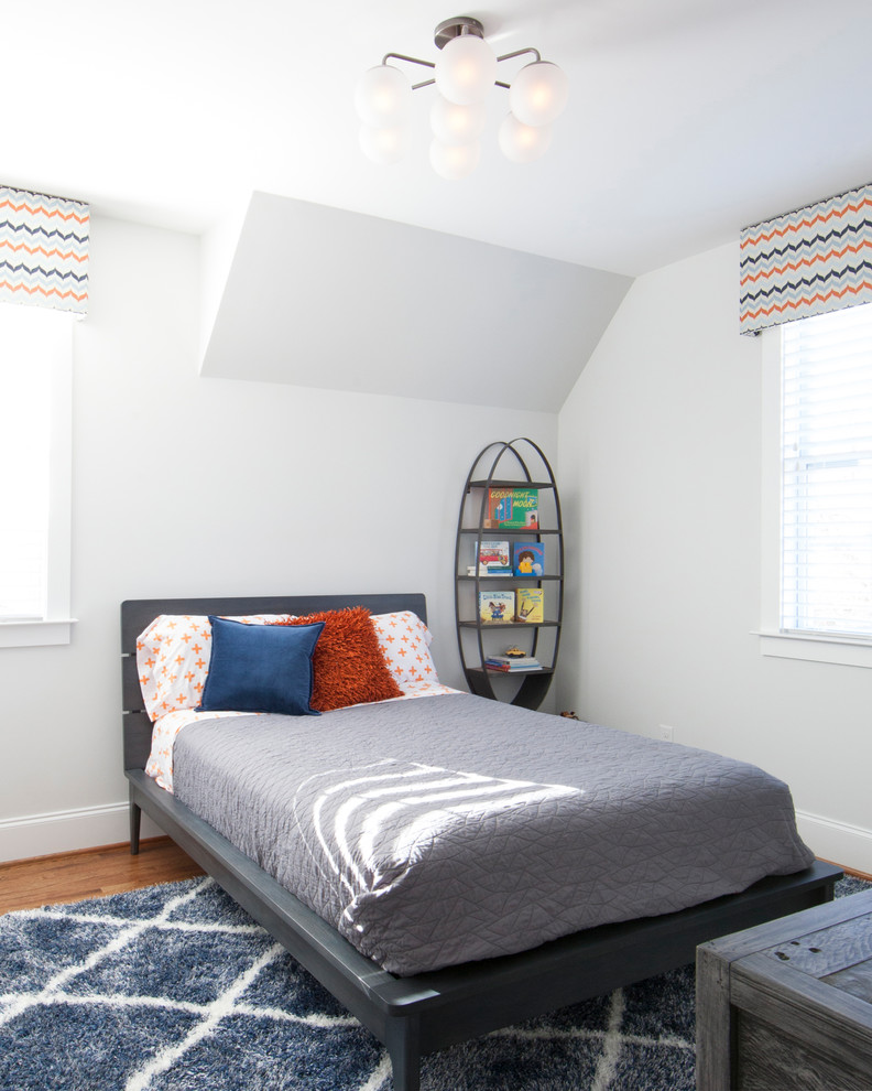 Design ideas for a transitional kids' bedroom for kids 4-10 years old and boys in Charlotte with white walls, medium hardwood floors and brown floor.