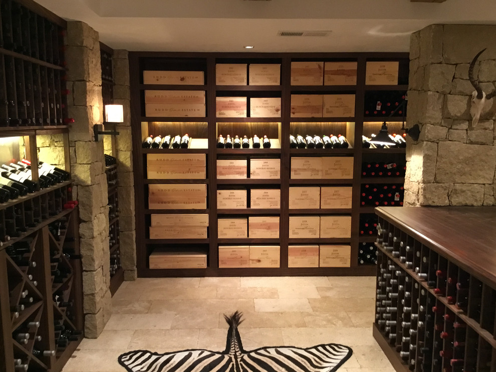 This is an example of a large country wine cellar in New York with limestone floors, storage racks and grey floor.