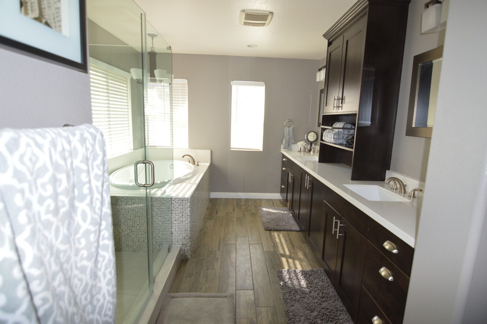Design ideas for a large transitional master bathroom in Los Angeles with engineered quartz benchtops, shaker cabinets, dark wood cabinets, an alcove tub, an alcove shower, a two-piece toilet, blue tile, gray tile, mosaic tile, grey walls, laminate floors and an undermount sink.