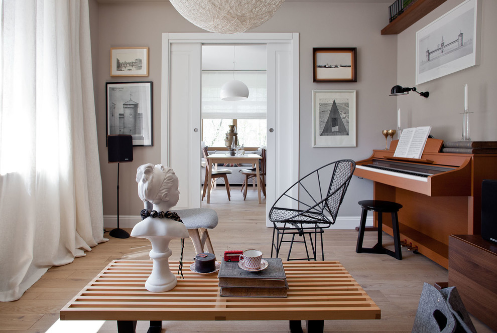 Inspiration for a scandinavian enclosed living room in Moscow with a music area, grey walls and light hardwood floors.