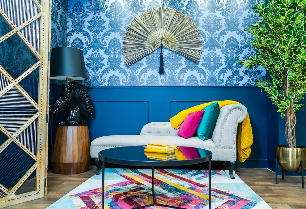 This is an example of a classic living room in London with blue walls, carpet and multi-coloured floors.